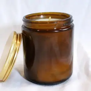 Ola Balms lotion candle showing amber jar